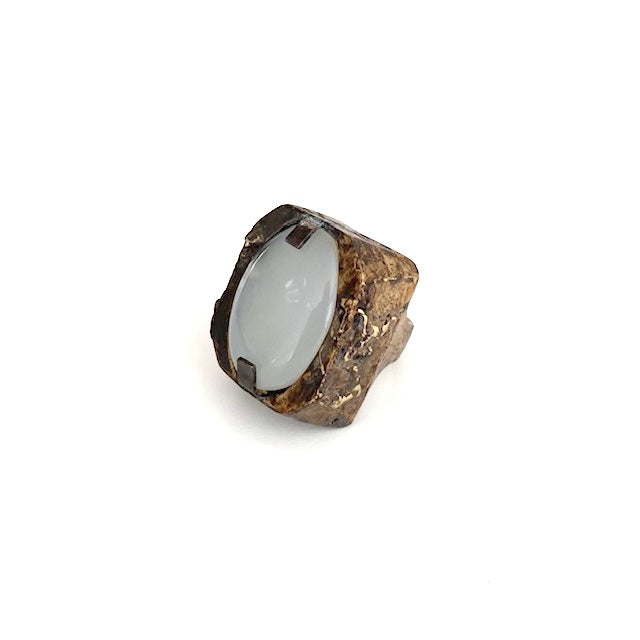 Bague Sculpturale rectangulaire en bronze patiné et texturé accueille une grande agate blanche ovale tenue par deux griffes de chaque côté.