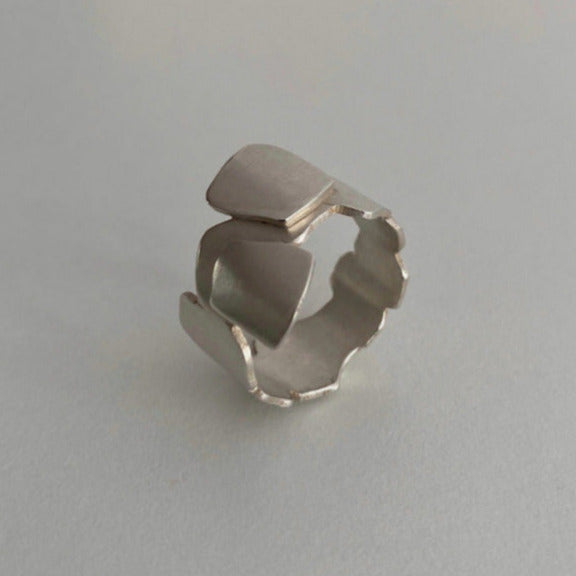 Bague géométrique en argent brossé formée de carrés irréguliers en forme de pavé.