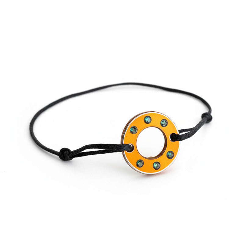 Bracelet Ready-Made, petit modèle est façonné d'une rondelle en aluminium orange et six tourmalines vertes. bijou upcyclé, présenté sur lien de coton réglable. Un bracelet au design contemporain à porter au quotidien, signé Studio C.